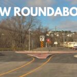 white text "NEW ROUNDABOUT" over image of new roundabout in Fredericton