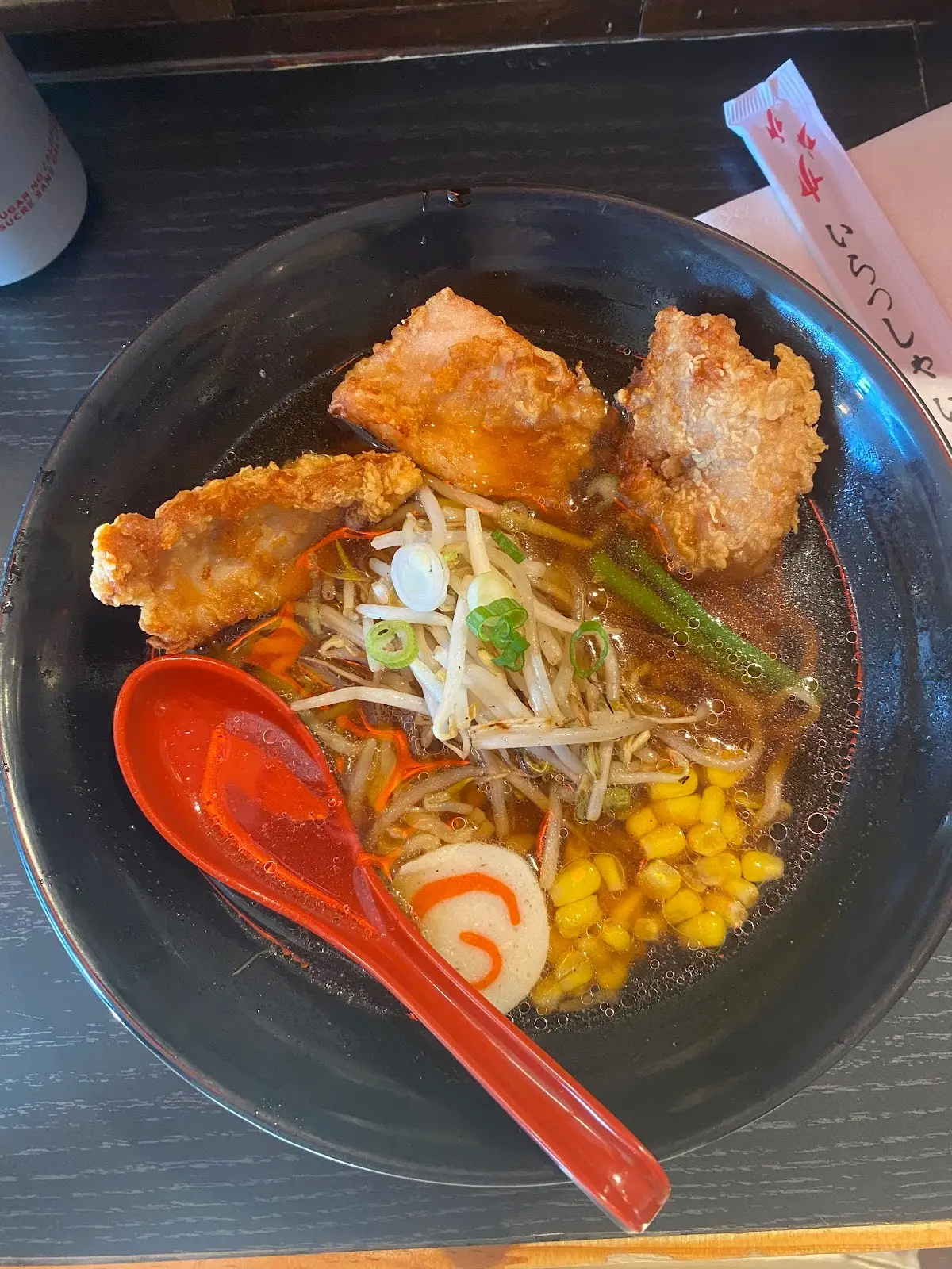 bowl of ramen with breaded chicken and veggies.