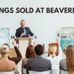 black writing "PAINTINGS SOLD AT BEAVERBROOK" above image of people participating in an art auction